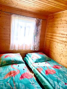 Postel nebo postele na pokoji v ubytování Domki w Rusinowie u Gosi + 15 fotografií