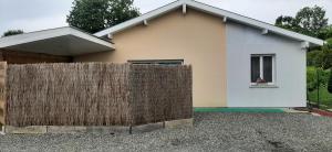 a house with a wooden fence in front of it at Appartement cosy 4 personnes in Benesse-lez Dax