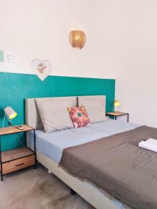 a bedroom with a bed with a green wall at 13 Palm Tree in Kralendijk +23 photos