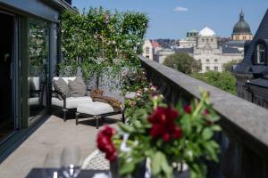 uma varanda com duas cadeiras e uma mesa com flores em Bank Hotel, a Member of Small Luxury Hotels em Estocolmo