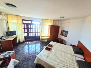 a living room with a bed and a desk at Алми Almi in Sveti Vlas