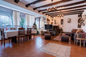a living room with a table and a christmas tree at Casa Veveritelor in Bran