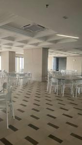 a large room with tables and chairs in a building at Homestay at Dian Residency in Shah Alam
