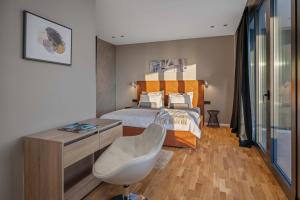 a bedroom with a bed and a desk and a chair at Villa She Luxury in Boškari +61 photos