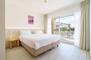 a bedroom with a large bed and a large window at Résidence Ibaïa in Hendaye +44 photos