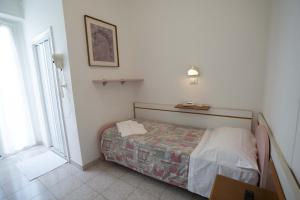 Postel nebo postele na pokoji v ubytování Hotel Odeon