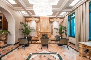 a dining room with a fireplace and a chandelier at LaFe Boutique Hotel in Sarandë