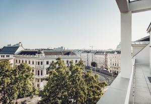 a view of the city from the roof of a building at Grand Ferdinand Vienna – Your Hotel In The City Center in Vienna