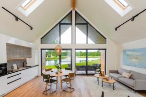 a living room with a table and a couch at Resort 23 in Želviai