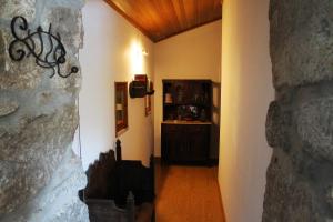a hallway leading to a room with a book shelf at Casa do Rio - Eido do Pomar in Arcos de Valdevez