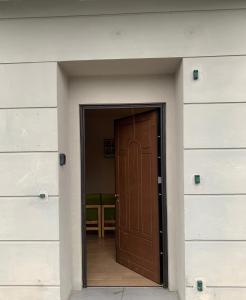 a brown door in a building with white walls at Udine Station Apartment in Udine