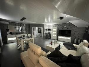 a living room with a couch and a table at Five Stars Living Whirlpool & Infrarotsauna in Hövelhof