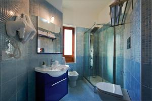 a bathroom with a sink and a toilet and a shower at B&B Suite 123 in Battipaglia