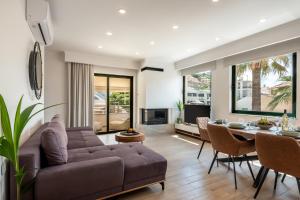 a living room with a couch and a table at Modern Dream Apartment in Plataniás