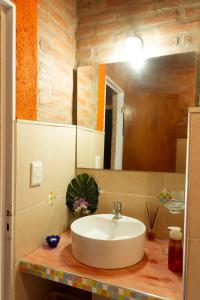 a bathroom with a sink and a mirror at Complejo Utopia-Chacras de la Primavera, Tanti in Tanti