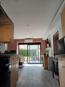 a large kitchen with an open door to a patio at Disneyland Paris Studio avec Terrasse in Chalifert +20 photos