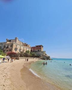 a beach with a group of people in the water at Ca' Sole in Butera +51 photos