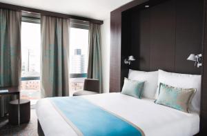 a hotel room with a large bed and a window at Motel One Manchester-Piccadilly in Manchester