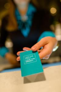 a person holding up a sign with their hand at Motel One Manchester-Piccadilly in Manchester