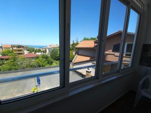 a window with a view of a swimming pool at Къща за гости Ани in Chernomorets