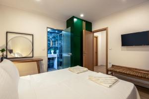 a bedroom with a bed and a tv on the wall at Modern Dream Apartment in Plataniás +19 photos