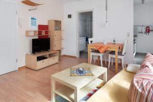 a living room with a couch and a table at Ferienwohnung zur Schauinslandbahn in Horben +18 photos