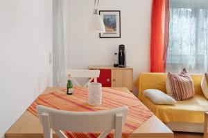 a dining room table with a bottle of wine on it at Ferienwohnung zur Schauinslandbahn in Horben