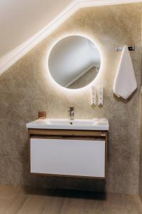 a bathroom with a sink and a mirror at Eduard Hotel in Uzhhorod