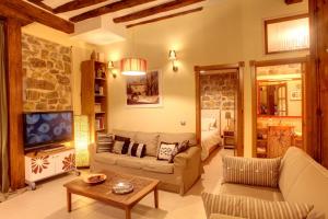 - un salon avec un canapé et une télévision dans l'établissement Casa Rural Siguenza Domus 200m2 de Vivienda y Exterior, à Sigüenza