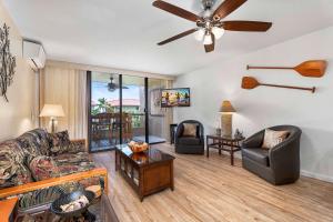 a living room with a couch and a ceiling fan at Kona Pacific D524 Kauhale in Kailua-Kona