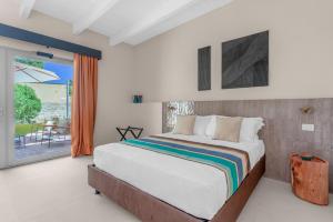 a bedroom with a large bed and a sliding glass door at Sabhé Gallipoli in Gallipoli