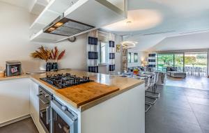 a kitchen with a stove and a counter top at Luxury villa Lara with private pool in Banjole