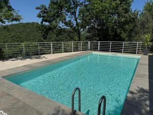 a swimming pool with blue water in front of a fence at Lory's Home in Caiazzo