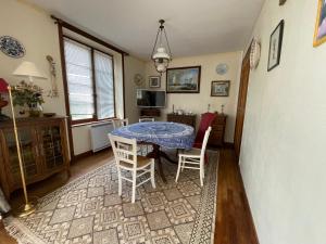 a dining room with a blue table and chairs at Maison vintage en bord de mer in Loctudy +21 photos