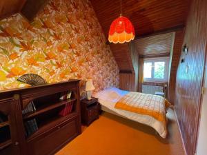 a bedroom with a bed with a colorful wall at Maison vintage en bord de mer in Loctudy