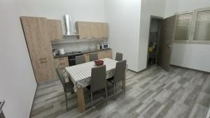a kitchen with a table and chairs in a room at Blu In in Palma di Montechiaro