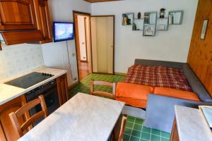 a small kitchen with a bed in a room at Casa Herin-La borna du Tésòn - CIR VDA - VALTOURNENCHE - n 0254 in Valtournenche