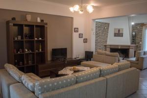 a living room with two couches and a fireplace at Nafpaktos comfort guest house in Nafpaktos