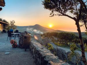 two people sitting at a table watching the sunset at Agriturismo Monte Istulargiu in Valledoria