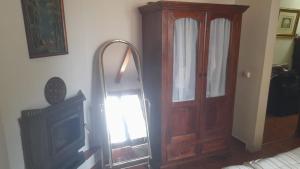 a room with a mirror next to a wooden door at Habitacion en Casa Huelves in Huelves +2 photos