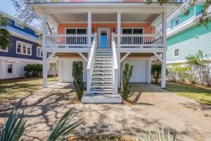 a house with a staircase in front of it at After Dune Delight in Kure Beach