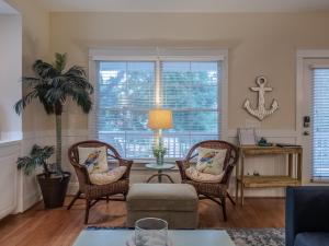 a living room with two chairs and a table at After Dune Delight in Kure Beach