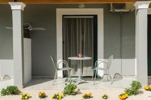 a table and chairs on a patio with flowers at Celestial Studios in Kavos