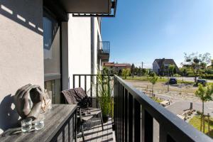 a balcony of a building with a view of a street at Baltic Line Marina-Mewa in Gdańsk +16 photos