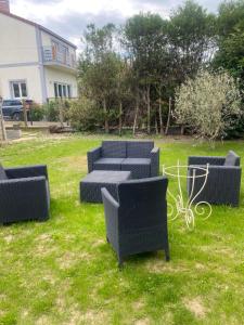 a group of chairs and tables in the grass at L’amazone in Sannois