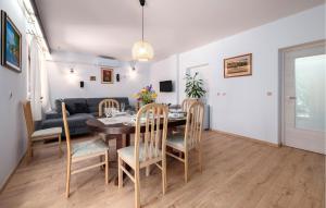 a dining room and living room with a table and chairs at Nice Apartment In Valbandon With Wifi in Valbandon