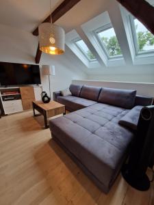 a living room with a couch and a tv at Graz City Center Apartments in Graz