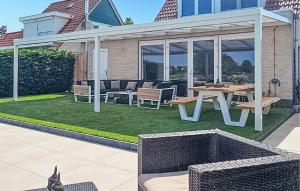 a patio with a table and chairs and a picnic table at Porta Isola - Villa Water in Stevensweert +8 photos