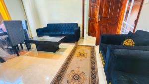 a living room with a couch and a coffee table at Aqua Apartment Murree in Murree