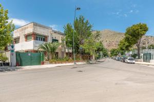 an empty street with a building on the side of the road at Villino Alice a Mondello by Wonderful Italy in Palermo